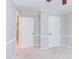 Bedroom featuring neutral walls and trim, carpet flooring, and multiple entry points at 8124 Greywinds Dr, Raleigh, NC 27615
