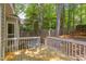 Exterior deck view featuring wood boards, white railing, and backyard foliage at 8124 Greywinds Dr, Raleigh, NC 27615