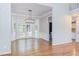 Inviting dining room area with hardwood floors, large bay window, and modern light fixture at 8124 Greywinds Dr, Raleigh, NC 27615
