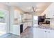 Modern kitchen with granite counters, white cabinets, black appliances, and a view to the deck at 8124 Greywinds Dr, Raleigh, NC 27615