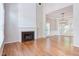 Spacious living room with a fireplace, hardwood floors, and ample natural light at 8124 Greywinds Dr, Raleigh, NC 27615