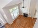 Spacious living room with hardwood floors, fireplace, and large windows offering natural light at 8124 Greywinds Dr, Raleigh, NC 27615