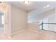 Cozy loft area featuring neutral paint, carpet flooring, and railing overlooking open space at 8124 Greywinds Dr, Raleigh, NC 27615