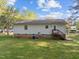 View of backyard with green grass and small porch at 84 Honeysuckle Dr, Pittsboro, NC 27312