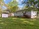 Spacious backyard with lush green grass, storage shed and small porch at 84 Honeysuckle Dr, Pittsboro, NC 27312