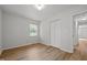 This bedroom features light gray walls, wood-look flooring, a window, and a closet at 84 Honeysuckle Dr, Pittsboro, NC 27312