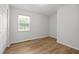 Bright bedroom features new hardwood flooring, a window, and neutral paint at 84 Honeysuckle Dr, Pittsboro, NC 27312