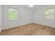 Empty bedroom with two windows, neutral paint, new flooring, and ceiling fan at 84 Honeysuckle Dr, Pittsboro, NC 27312