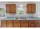Wooden cabinets with stainless sink in a modern kitchen with bright countertops and a window at 84 Honeysuckle Dr, Pittsboro, NC 27312