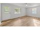 Sunlit living room with LVP flooring, ceiling fan, and a back door to the yard at 84 Honeysuckle Dr, Pittsboro, NC 27312