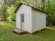 Small storage shed with wooden door at 84 Honeysuckle Dr, Pittsboro, NC 27312