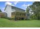 Spacious backyard featuring a covered porch, ideal for entertaining, surrounded by lush green grass and mature trees at 8704 Maxine St # 1, Willow Springs, NC 27592