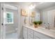 Bright bathroom features a double vanity with framed mirrors, and a window overlooking the backyard at 8704 Maxine St # 1, Willow Springs, NC 27592