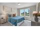 Bright bedroom features neutral colors, contemporary art, and a view of the outdoors at 8704 Maxine St # 1, Willow Springs, NC 27592