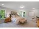 Bright bedroom featuring plush carpet, generous natural light, and stylish, comfortable furnishings at 8704 Maxine St # 1, Willow Springs, NC 27592