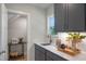 Convenient butler's pantry featuring gray cabinets, a sink, quartz countertops, and a window for natural light at 8704 Maxine St # 1, Willow Springs, NC 27592