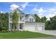 Beautiful two-story home featuring a brick facade, inviting porch, balcony, and well-manicured lawn at 8704 Maxine St # 1, Willow Springs, NC 27592