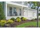 Charming two-story home featuring a covered front porch with rocking chairs and landscaped garden at 8704 Maxine St # 1, Willow Springs, NC 27592