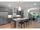 Modern kitchen with gray cabinetry, stainless steel appliances, and a large island with seating at 8704 Maxine St # 1, Willow Springs, NC 27592