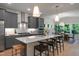 Modern kitchen boasts gray cabinets, stainless steel appliances, a large island with bar seating, and stylish pendant lighting at 8704 Maxine St # 1, Willow Springs, NC 27592