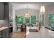 Open-concept kitchen and dining area with gray cabinets, modern lighting, and a view of the dining space at 8704 Maxine St # 1, Willow Springs, NC 27592