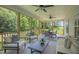 Large screened patio features comfortable seating, a dining table, and wooded views at 8704 Maxine St # 1, Willow Springs, NC 27592
