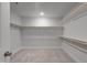 Spacious walk-in closet with carpeting, white trim, and wood closet rods at 8704 Maxine St # 1, Willow Springs, NC 27592