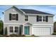 Charming two-story home features a gray exterior, black shutters, manicured landscaping, and a two-car garage at 91 Gobbler Dr, Smithfield, NC 27577