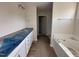 Bright bathroom features dual sink vanity with granite counters and a separate soaking tub at 10 Silver Ct, Smithfield, NC 27577