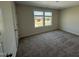 Bright bedroom with neutral carpet and a large window providing plenty of natural light and serene views at 10 Silver Ct, Smithfield, NC 27577