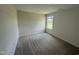 A carpeted bedroom with a bright window showcases ample space and natural light at 10 Silver Ct, Smithfield, NC 27577