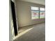 Bedroom with neutral tones, carpeting, and natural light from a large window at 10 Silver Ct, Smithfield, NC 27577