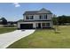 Charming two-story home featuring a black two-car garage and a well-manicured lawn on a sunny day at 10 Silver Ct, Smithfield, NC 27577