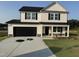 Charming two-story home with a black two-car garage and covered porch at 10 Silver Ct, Smithfield, NC 27577