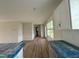 Modern kitchen with white cabinets and a long view to the living area and back door at 10 Silver Ct, Smithfield, NC 27577