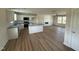 Bright open-concept kitchen featuring white cabinets, modern appliances, new floors, and recessed lighting throughout at 10 Silver Ct, Smithfield, NC 27577