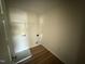 Compact laundry room with new floors, featuring a washer hookup and an upper shelf for added storage at 10 Silver Ct, Smithfield, NC 27577