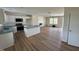 Open-concept living space with kitchen, island, and wood floors, creating an inviting atmosphere at 10 Silver Ct, Smithfield, NC 27577