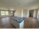 Bright open-concept living area featuring new floors, recessed lighting, and a kitchen island with modern finishes at 10 Silver Ct, Smithfield, NC 27577