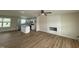 Open-concept living room and kitchen with modern wood-look floors and a fireplace feature wall at 10 Silver Ct, Smithfield, NC 27577
