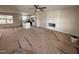 Open-concept living space with fireplace, ceiling fan, and adjacent kitchen area at 10 Silver Ct, Smithfield, NC 27577