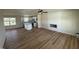 Spacious living room featuring wood-look flooring, a ceiling fan, and a cozy fireplace with modern white shiplap at 10 Silver Ct, Smithfield, NC 27577