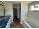Main bathroom with granite countertop vanity, soaking tub, glass enclosed shower, and wood-look flooring at 10 Silver Ct, Smithfield, NC 27577