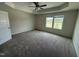 Carpeted primary bedroom featuring a tray ceiling, double windows offering natural light at 10 Silver Ct, Smithfield, NC 27577