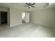 Spacious main bedroom featuring ceiling fan and ensuite bathroom entrance at 10 Silver Ct, Smithfield, NC 27577