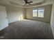 Large main bedroom featuring plush carpeting, a tray ceiling and plenty of natural light at 10 Silver Ct, Smithfield, NC 27577