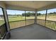 Screened patio with outdoor views of the property and a black railing at 10 Silver Ct, Smithfield, NC 27577