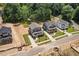 New construction homes on landscaped lots with sidewalks and paved street in a lush forested area at 1005 Forrestal Pl, Durham, NC 27707