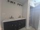 Modern bathroom with a double sink vanity, matte black fixtures, and a closet at 1005 Forrestal Pl, Durham, NC 27707