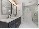 Modern bathroom with double vanity, elegant fixtures, and glass enclosed shower at 1005 Forrestal Pl, Durham, NC 27707